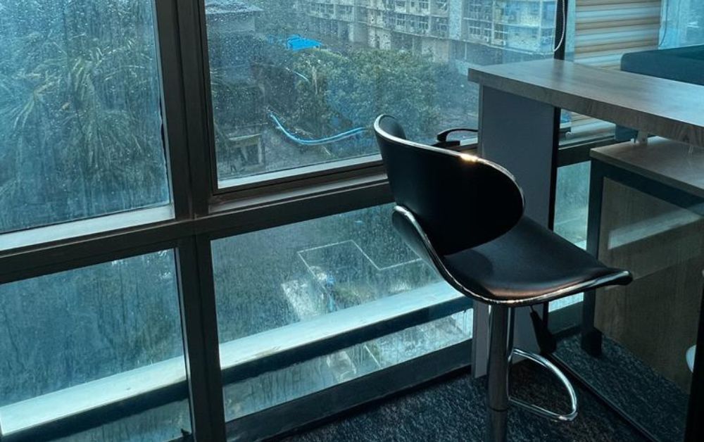  Dedicated Desk at window with city view at Executive Spaces coworking office in Lotus Corporate Park, Goregaon East